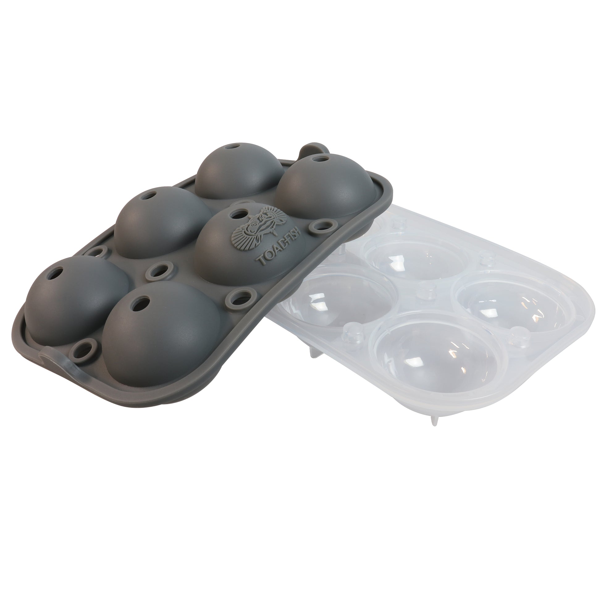 A silicone ice ball freezer tray with six spherical cavities, alongside a clear plastic tray for the same purpose.